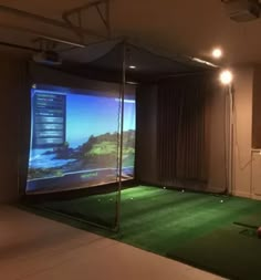 an indoor golf simulator is set up to allow players to play on the television screen