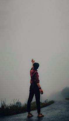 a person walking down a road in the rain