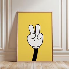 a yellow poster with a peace sign drawn on it in front of a white wall