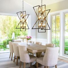 a dining room table and chairs with chandelier hanging from the ceiling