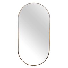 an oval mirror with a gold frame and metal trim on the bottom, against a white background