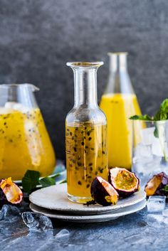 a glass bottle filled with liquid sitting on top of a plate next to other bottles