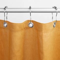 an orange curtain hanging from a metal rod