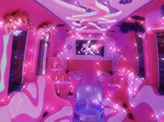 the interior of a vehicle with pink and purple lights on it's walls, decorated with stars