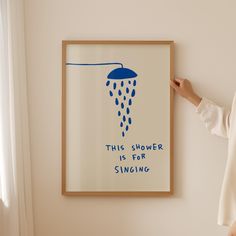 a woman standing in front of a poster with the words, this shower is for singing