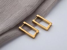 ♥ ∙E A R R I N G S♥ * Material: High Quality Titanium Steel * Finish: Titanium Steel 14K Gold Pated  * Featuring: Water-Resistant, Anti Tarnish, Hypoallergenic This trendy Rectangle earrings are made of titanium steel with a thick 14k gold platted It is designed for your daily wear look Minimalist and Beautiful The simple yet timeless design makes it a good addition to your jewelry collection.14K gold plated brass *instructions on how to take care plated Earrings. *Avoid water and chemicals: Avo Cheap Hypoallergenic Rectangular Earrings, Luxury Elegant Square Hoop Earrings, Rectangular Earrings, Punk Earrings, Titanium Earrings, Luxury Earrings, Party Earrings, Square Stud, Trendy Earrings