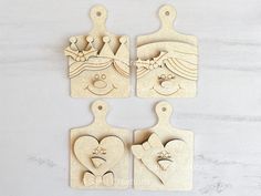 four wooden cutting boards with hearts and faces on them