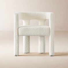 a white chair made out of sheepskins on a beige background with the seat up