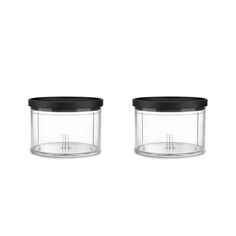 two clear jars with black lids on white background