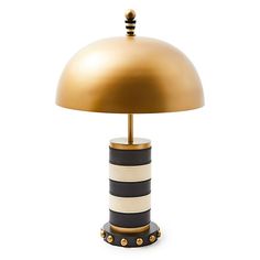 a black and white striped lamp with a gold dome shade