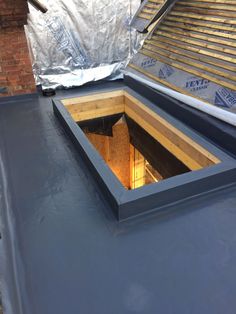 the roof is being fitted with insulation and tarp to protect it from falling down