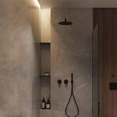 a bathroom with a sink, toilet and shower head mounted to the side of the wall