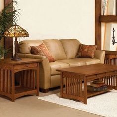 a living room filled with furniture and a lamp on top of a wooden coffee table