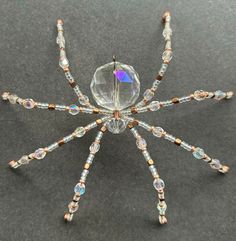 a crystal beaded spider on a black surface