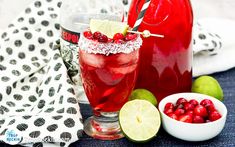 two glasses filled with cranberry lemonade and garnished with limes