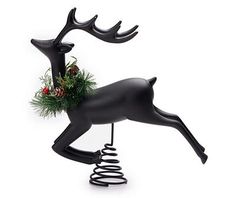 a black reindeer with a wreath on its antlers