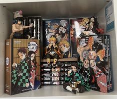 some anime figurines are on display in a shelf