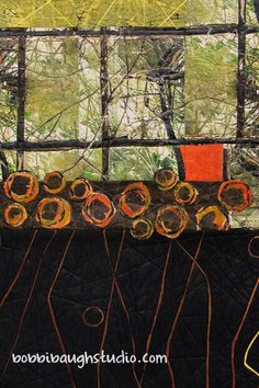 an abstract painting with orange and yellow circles on black paper, in front of a window