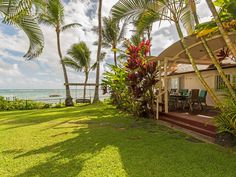 a house on the beach with palm trees