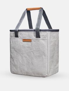 a large gray bag sitting on top of a white table next to a wooden handle