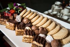 a white plate topped with lots of different types of desserts on top of it