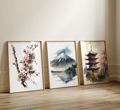 three watercolor paintings are displayed on the wall next to each other in an empty room