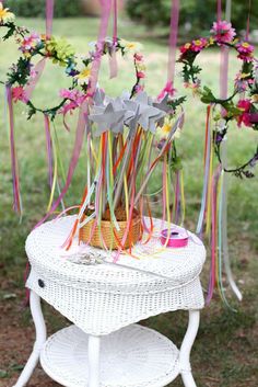 a white table topped with flowers and ribbons