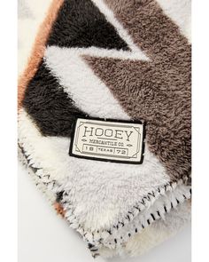 the label is on an animal - print blanket that has been made with wool and leather