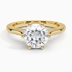 a yellow gold engagement ring with a round cut diamond