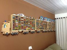 a toy truck is mounted to the side of a wall with legos on it