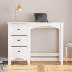 a white desk with a laptop on it