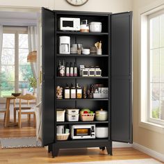 a black cabinet filled with lots of items next to a clock on the wall in a room