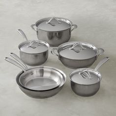 an assortment of pots and pans with lids