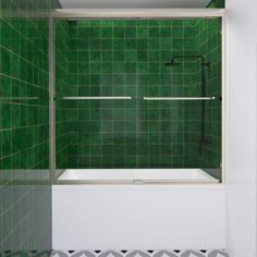 a green tiled bathroom with a tub and shower