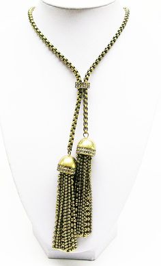 Finished in  Antique  gold  tone, signed, Gold Tassel Dangle Necklace Gift, Gold Tassel Dangle Necklace, Adjustable Gold Metal Long Necklace, Adjustable Gold Tassel Necklace With Fringe, Gold Tassel Necklace For Party, Gold Metal Long Lariat Necklace, Bohemian Gold Drop Necklace With Adjustable Chain, Gold Bohemian Drop Necklace With Adjustable Chain, Bohemian Gold Tassel Necklace For Party