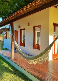 a hammock hanging from the side of a house