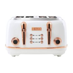 a white toaster with copper trimmings on the front and two black knobs