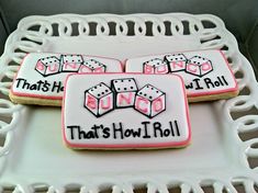 three decorated cookies sitting on top of a white tray with words that says, that's how i roll