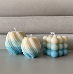 three vases sitting on top of a table next to each other in front of a couch