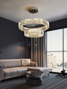 a living room with a couch, chair and chandelier hanging from the ceiling