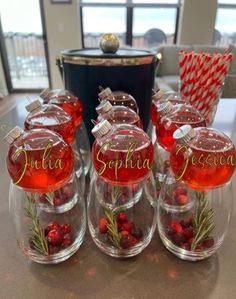 there are four glass jars with candy in them