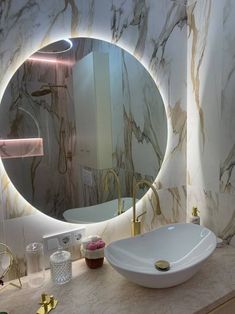 a bathroom with marble walls and a round mirror