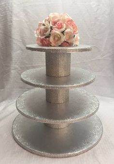 three tiered cake stand with flowers on top