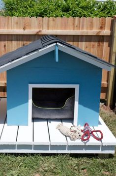 a dog house that is outside in the grass