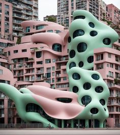 an unusual building in the middle of a city with pink and green buildings behind it