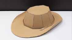 a brown paper hat sitting on top of a white table