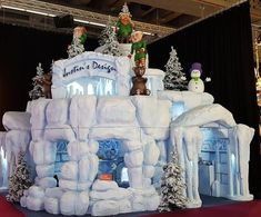 an ice sculpture with snowmen and santa clause on top