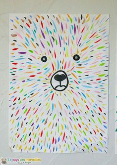 a bear made out of colored paint sprinkles on a white wall next to another painting