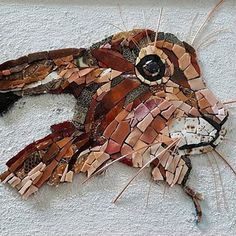 an animal made out of mosaic tiles on the side of a building