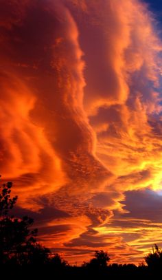 an orange and blue sky with some clouds